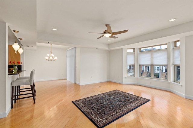 living area featuring ceiling fan, light wood-type flooring, a chandelier, baseboards, and recessed lighting