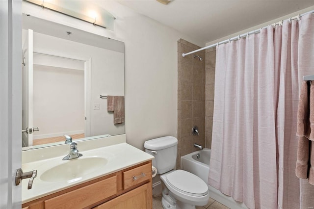 bathroom featuring toilet, shower / tub combo with curtain, vanity, and tile patterned floors