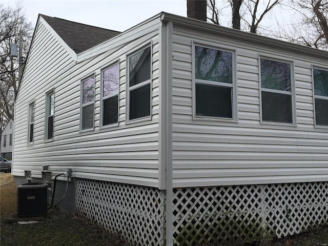 2812 Annapolis Ave, Saint Louis, MO 63114 - view of home's exterior featuring central AC unit, a chimney, and roof with shingles