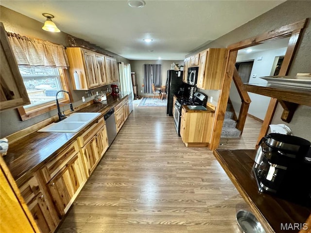 301 W Summer St, Monroe City, MO 63456 - kitchen featuring stainless steel appliances, a sink, light wood-type flooring, and wooden counters