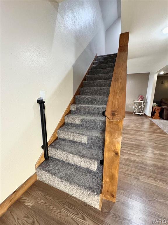 301 W Summer St, Monroe City, MO 63456 - staircase with wood finished floors, baseboards, and vaulted ceiling