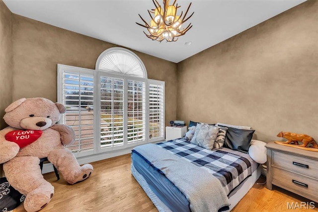 2942 Eagle Pointe Dr, Wentzville, MO 63385 - bedroom featuring wood finished floors, a chandelier, and access to outside