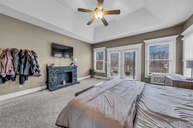 2942 Eagle Pointe Dr, Wentzville, MO 63385 - bedroom with a tray ceiling, carpet flooring, access to outside, a stone fireplace, and ceiling fan