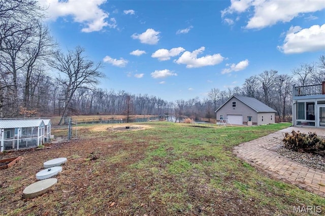 2942 Eagle Pointe Dr, Wentzville, MO 63385 - view of yard with an outdoor structure, a garage, a water view, and view of scattered trees