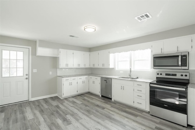 121 W Hicks St, Cardwell, MO 63829 - kitchen with appliances with stainless steel finishes, a sink, tasteful backsplash, light countertops, and healthy amount of natural light
