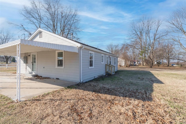 121 W Hicks St, Cardwell, MO 63829 - view of side of home with an attached carport and a yard