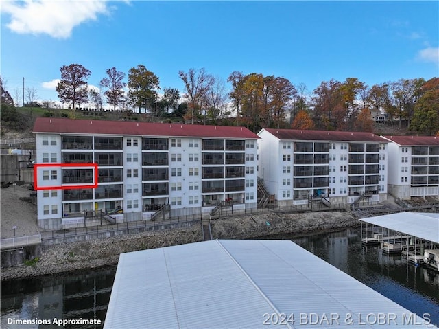 view of apartment building / complex with a water view