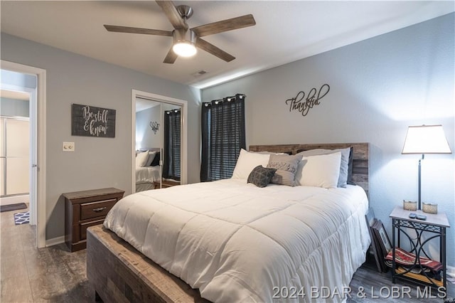 bedroom featuring wood finished floors, a closet, ceiling fan, and baseboards