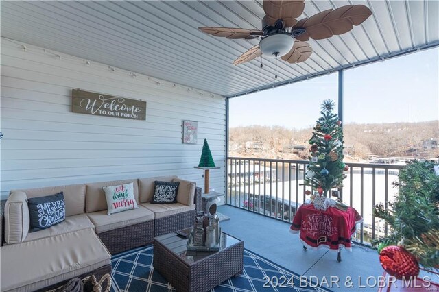view of patio featuring an outdoor living space, ceiling fan, and a balcony