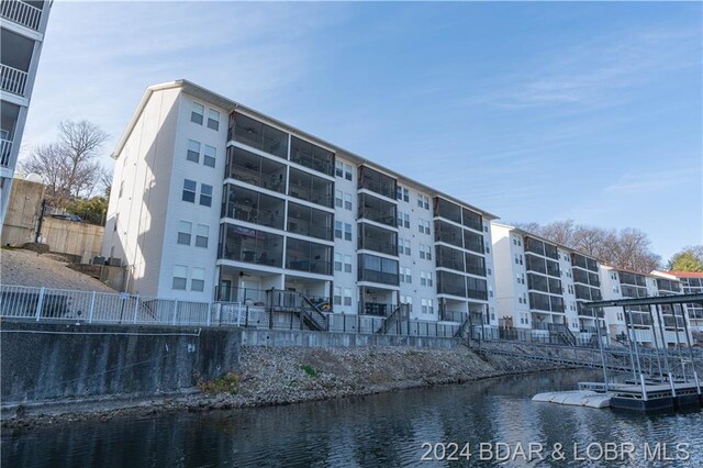 view of apartment building / complex with a water view
