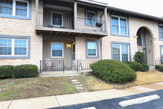 3181 Carefree Ln Unit A, Florissant, MO 63033 - view of front of house featuring a balcony, covered porch, and brick siding