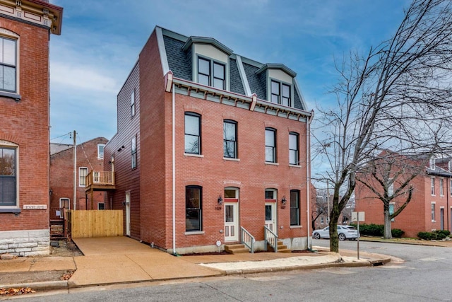 1029 Lami, Saint Louis, MO 63104 - view of front of house with mansard roof, brick siding, entry steps, roof with shingles, and fence
