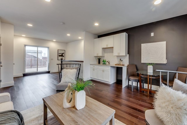 1029 Lami, Saint Louis, MO 63104 - living area featuring dark wood finished floors, baseboards, and recessed lighting