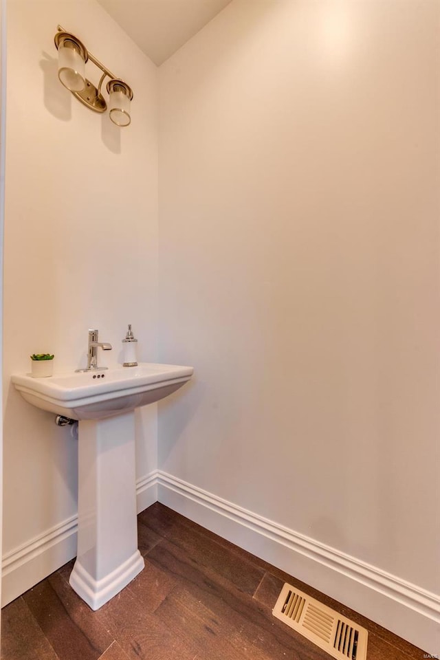 1029 Lami, Saint Louis, MO 63104 - bathroom featuring baseboards, wood finished floors, and a sink