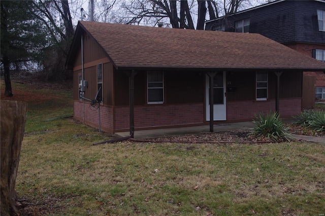 25 N 44th St, Belleville, IL 62226 - view of property exterior featuring brick siding, roof with shingles, and a lawn