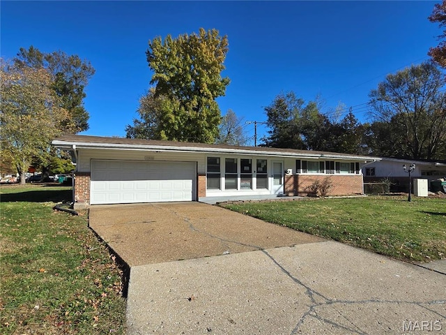 10468 Halls Ferry Rd, Saint Louis, MO 63136 - view of front of property featuring brick siding, a garage, driveway, and a front yard