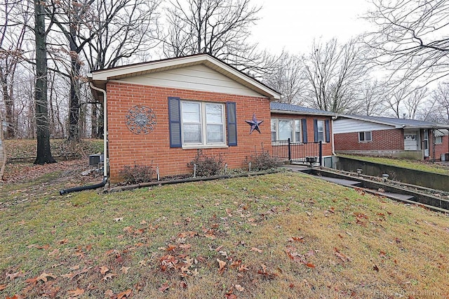 820 Sharon Dr, Cape Girardeau, MO 63701 - view of front of home featuring brick siding, a front lawn, and cooling unit