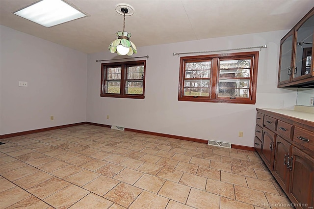 820 Sharon Dr, Cape Girardeau, MO 63701 - unfurnished dining area featuring plenty of natural light and baseboards