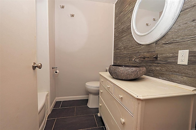 820 Sharon Dr, Cape Girardeau, MO 63701 - bathroom with tile patterned flooring, toilet, vanity, a tub, and baseboards