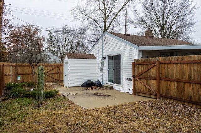 601 E Jefferson St, Ofallon, IL 62269 - back of house featuring a gate, a fenced backyard, a patio, and a shingled roof