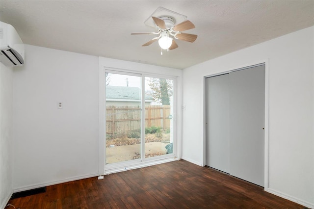 601 E Jefferson St, Ofallon, IL 62269 - unfurnished room with hardwood / wood-style flooring, a ceiling fan, a wall unit AC, and baseboards