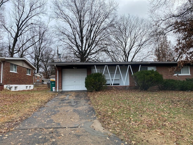 10514 Rothwell Dr, Saint Louis, MO 63136 - view of front of property with brick siding, a garage, driveway, and a front yard