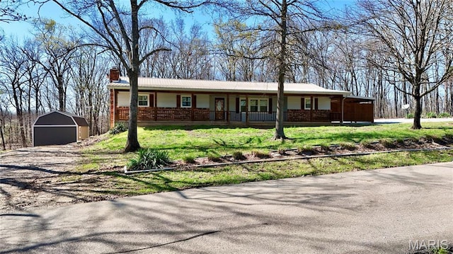 1034 Port Perry Dr, Perryville, MO 63775 - single story home featuring a shed, an outdoor structure, a porch, a garage, and a chimney