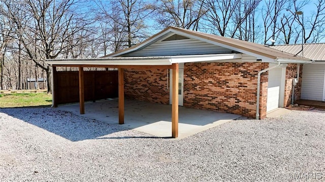 1034 Port Perry Dr, Perryville, MO 63775 - view of patio / terrace with an attached carport, driveway, and an attached garage