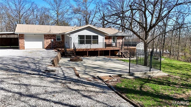 1034 Port Perry Dr, Perryville, MO 63775 - single story home featuring a garage, metal roof, brick siding, a deck, and a carport
