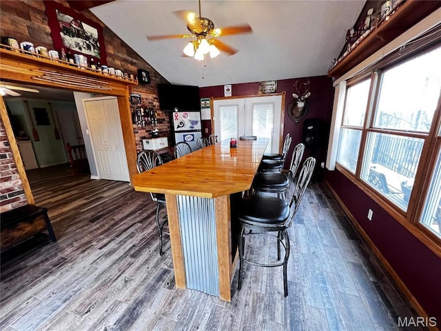 1034 Port Perry Dr, Perryville, MO 63775 - dining area with ceiling fan, vaulted ceiling, dark wood-style flooring, and baseboards