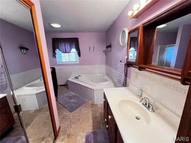 1034 Port Perry Dr, Perryville, MO 63775 - full bath with vanity, a textured ceiling, and a garden tub