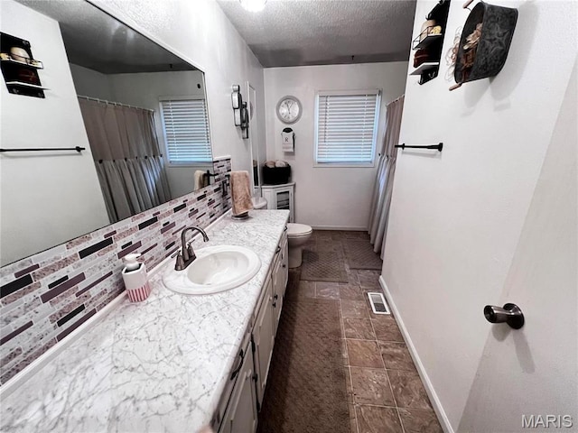 1034 Port Perry Dr, Perryville, MO 63775 - bathroom with vanity, a textured ceiling, toilet, baseboards, and a shower with curtain