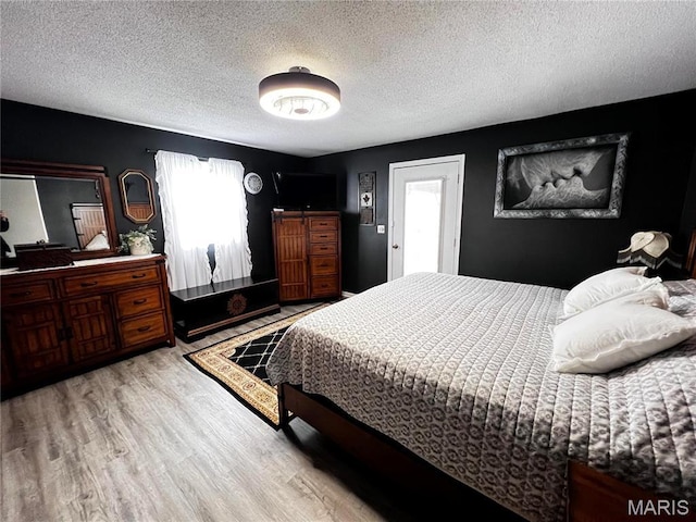 1034 Port Perry Dr, Perryville, MO 63775 - bedroom featuring wood finished floors and a textured ceiling