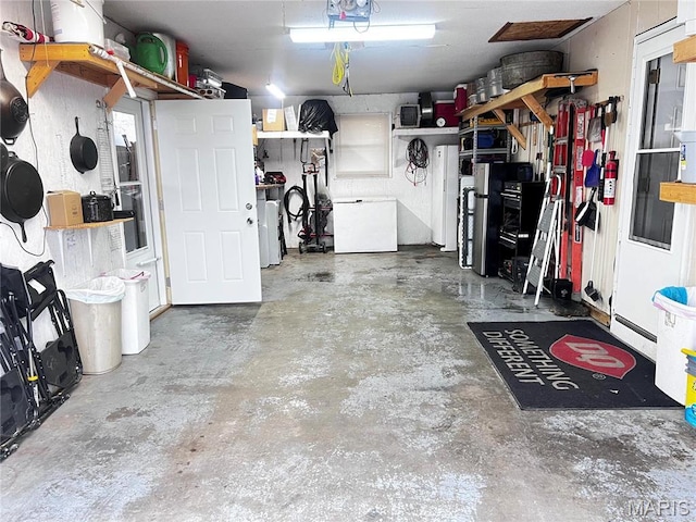 1034 Port Perry Dr, Perryville, MO 63775 - garage featuring fridge and a baseboard radiator