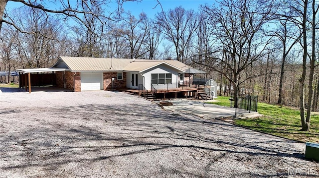 1034 Port Perry Dr, Perryville, MO 63775 - view of front of property featuring a wooden deck, driveway, a garage, and metal roof