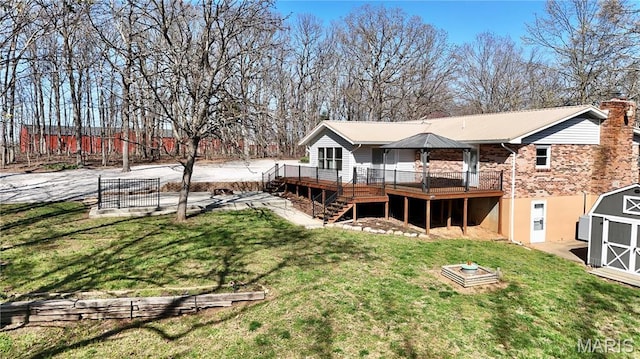 1034 Port Perry Dr, Perryville, MO 63775 - back of house with a storage shed, a wooden deck, an outdoor structure, stairway, and a chimney