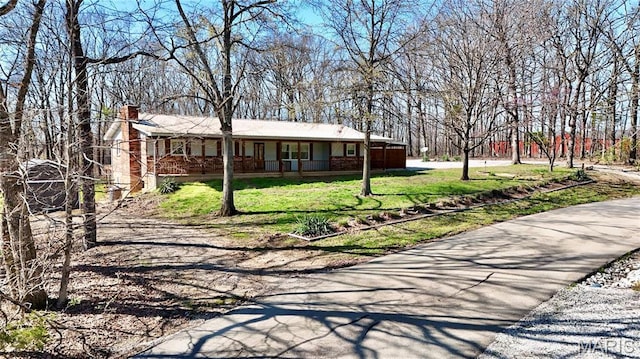 1034 Port Perry Dr, Perryville, MO 63775 - ranch-style house featuring covered porch, a chimney, and a front lawn