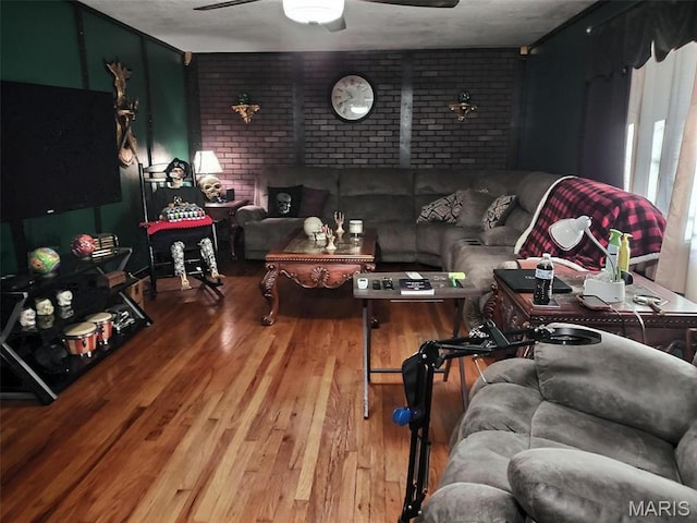 813 Kendall Dr, Poplar Bluff, MO 63901 - living room with brick wall, wood finished floors, and ceiling fan