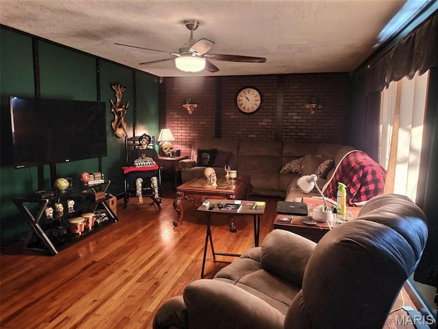 813 Kendall Dr, Poplar Bluff, MO 63901 - living area featuring ceiling fan, a textured ceiling, wood finished floors, and brick wall