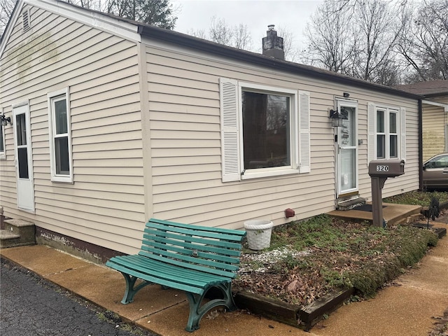 320 Geyer Rd, Kirkwood, MO 63122 - view of home's exterior with entry steps and a chimney