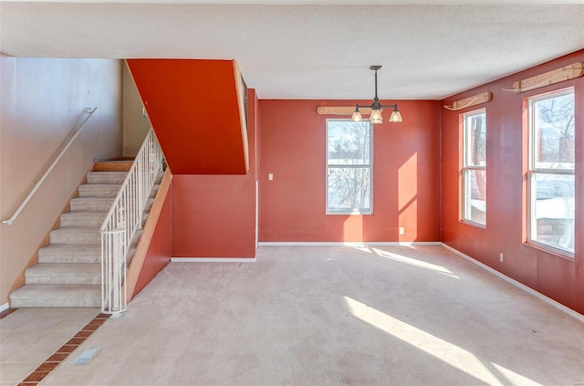 6866 Frandsen Rd, Alhambra, IL 62001 - unfurnished living room featuring baseboards, stairs, and carpet