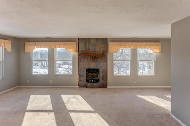 6866 Frandsen Rd, Alhambra, IL 62001 - unfurnished living room featuring heating unit, a textured ceiling, carpet floors, plenty of natural light, and baseboards