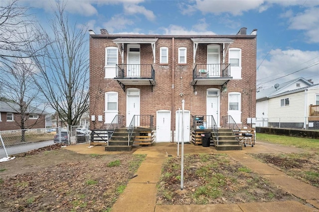 4201 Walsh St, Saint Louis, MO 63116 - townhome / multi-family property with a balcony, fence, and brick siding