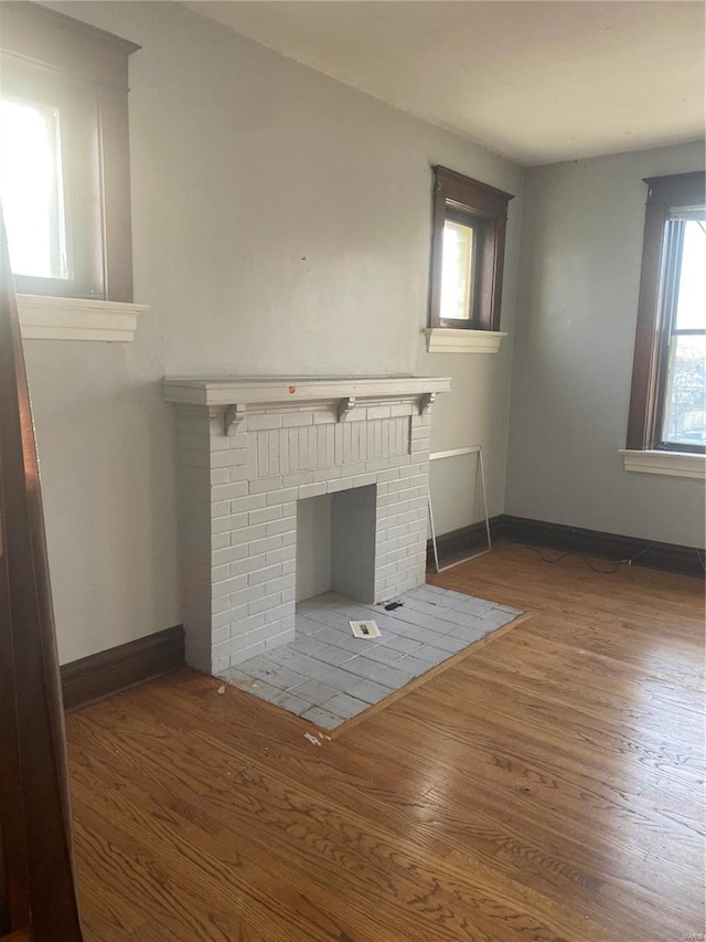 4201 Walsh St, Saint Louis, MO 63116 - unfurnished living room with wood finished floors, a fireplace, and baseboards