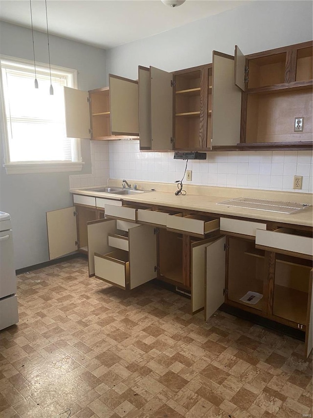 4201 Walsh St, Saint Louis, MO 63116 - kitchen featuring open shelves, decorative backsplash, hanging light fixtures, and light countertops