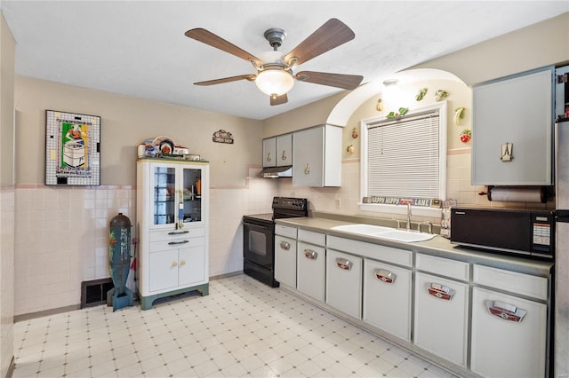 10319 Cable Ave, Frontenac, MO 63131 - kitchen featuring black appliances, a sink, under cabinet range hood, tile walls, and ceiling fan