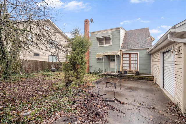 10319 Cable Ave, Frontenac, MO 63131 - back of house with a patio, fence, a chimney, and roof with shingles