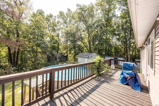 364 N 7th Ln, Fillmore, IL 62032 - deck with an outdoor pool, an outdoor structure, a storage unit, and view of wooded area