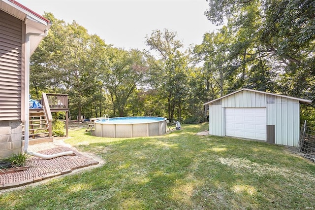 364 N 7th Ln, Fillmore, IL 62032 - view of grassy yard with a wooden deck, a detached garage, stairway, an outdoor pool, and an outbuilding