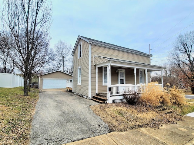 305 Macarthur St, Washington, MO 63090 - view of front facade with covered porch, an outdoor structure, a detached garage, and fence